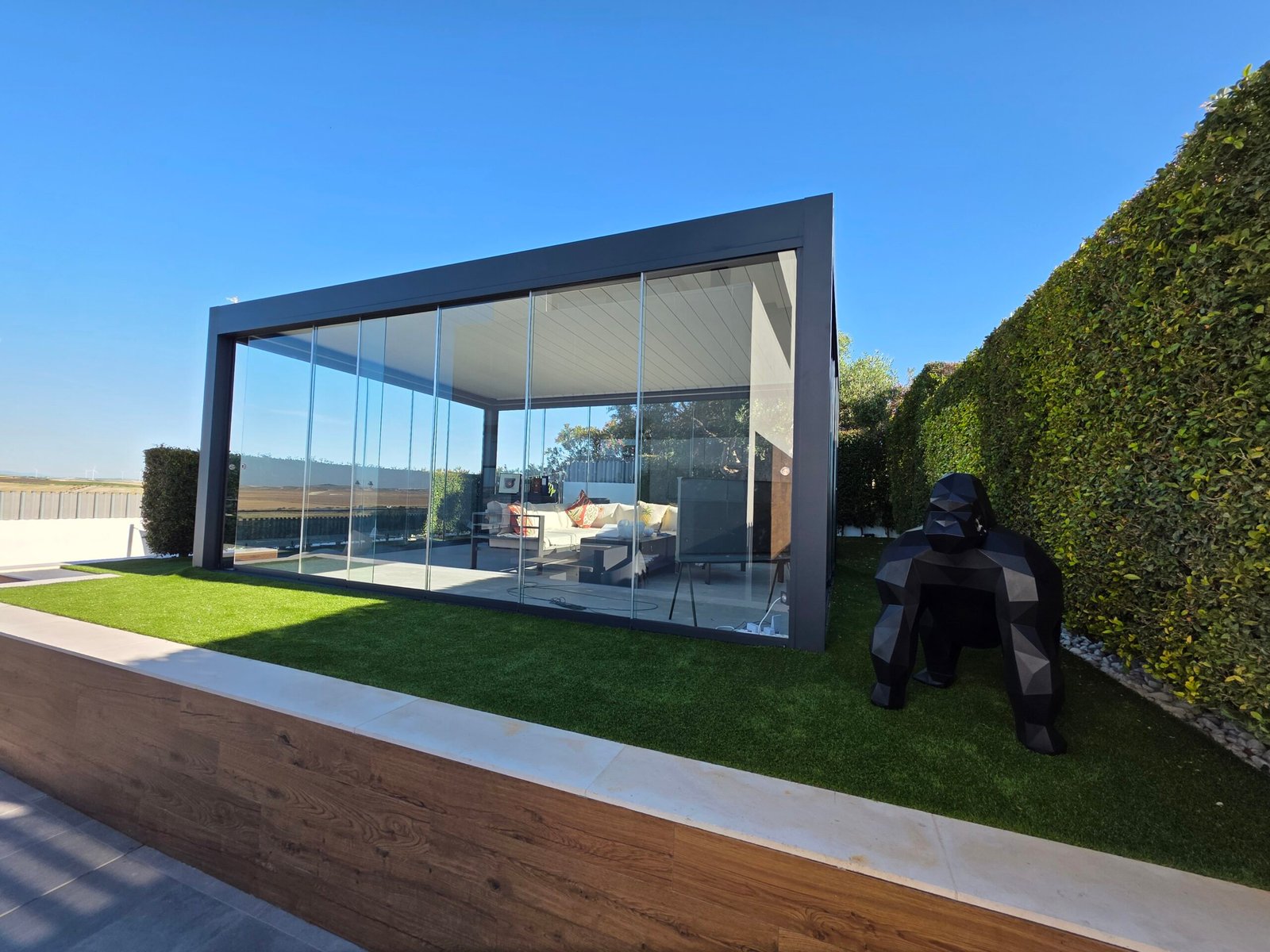 Pérgola bioclimática con cerramiento de cristal correderas ZOE, estructura de aluminio negro
